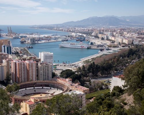 Stunning aerial view of Málaga, Spain, showcasing the port and coastline.